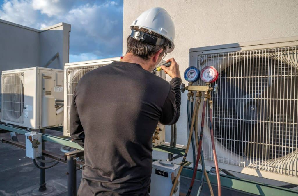 A professional HVAC technician, dressed in a clean uniform and equipped with modern tools, inspects a central air conditioning unit outside a well-maintained suburban home in a Texas neighborhood, set against a backdrop of lush greenery that conveys a sense of reliability, community, and the brand's commitment to quality services, with a warm color palette reflecting the Texas climate and incorporating shades of blue and green to symbolize cooling and plumbing services.